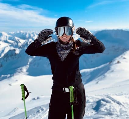 Elin Silverio with poles on a mountain summit