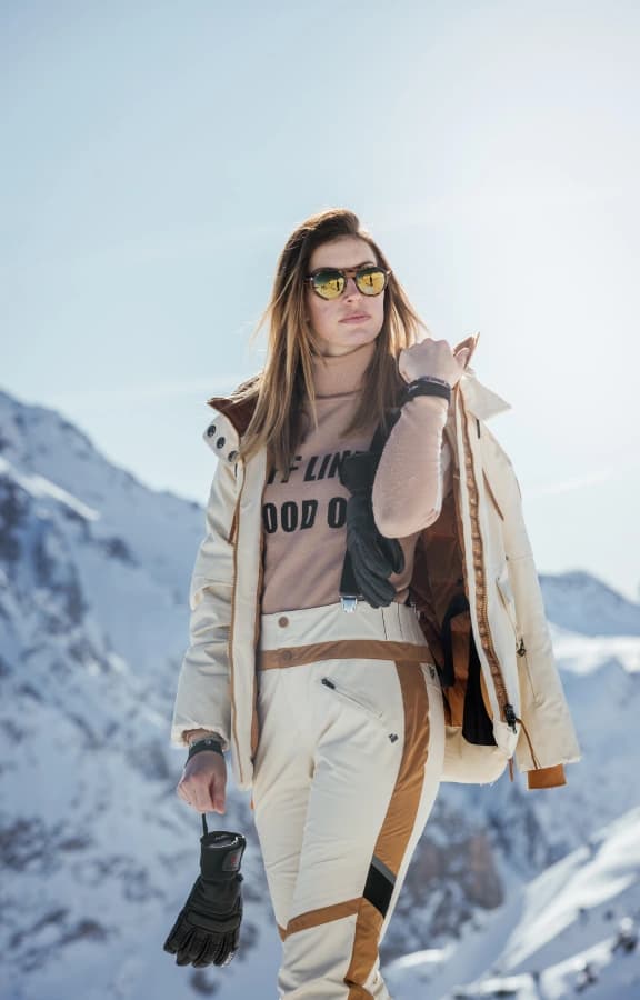 Cream ski outfit in the mountains