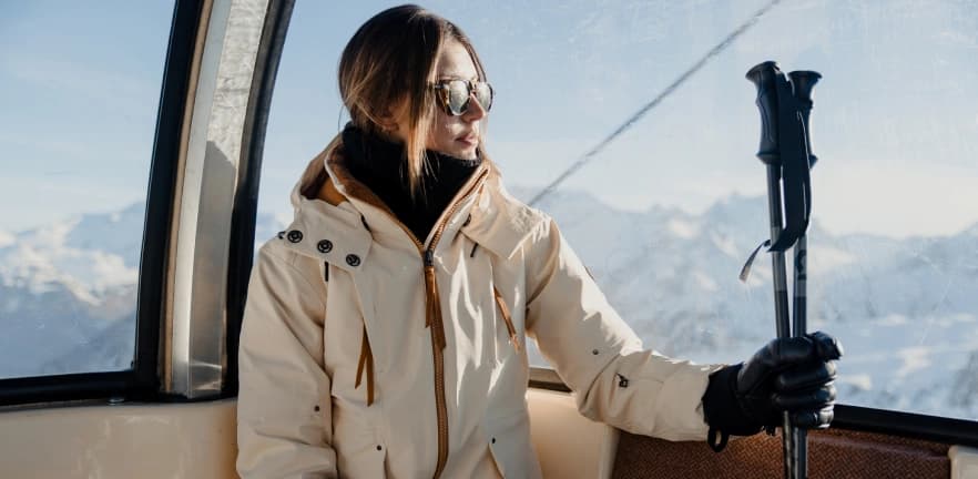Beige ski jacket in a gondola